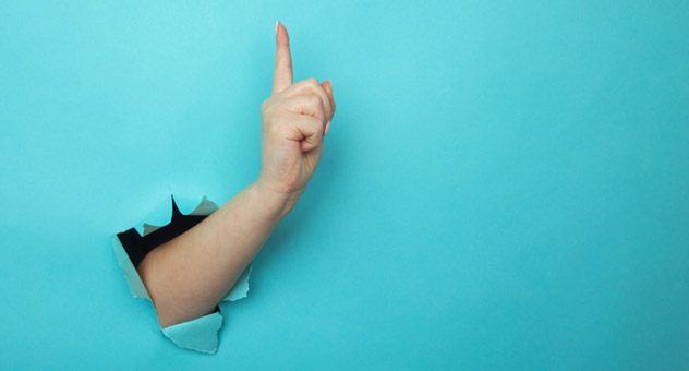 A hand breaking through a blue background and holding up its index finger (indicating the number one).